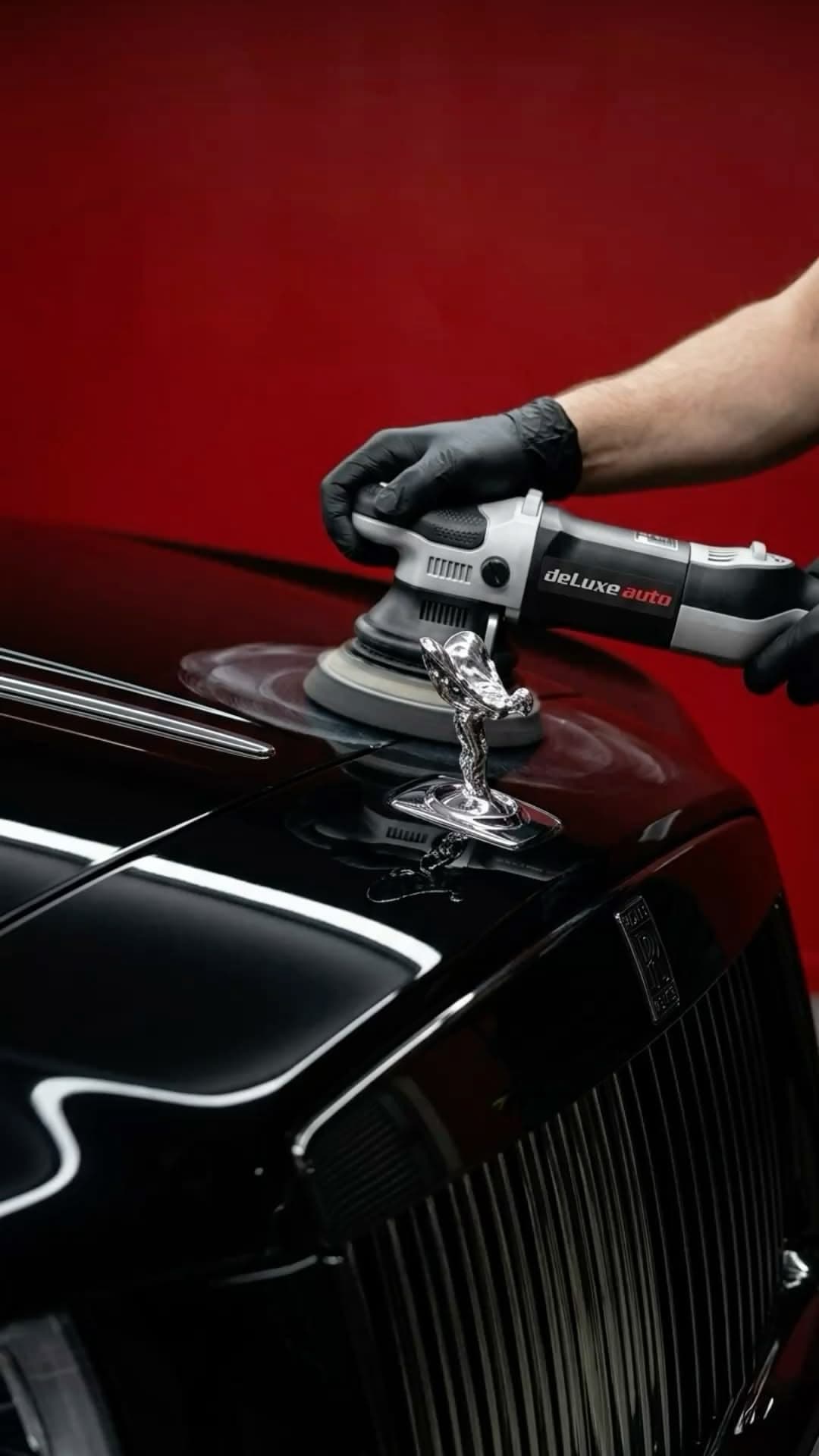Detailer wiping down a luxury car interior