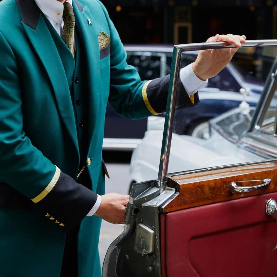 Valet attendant opening a guest's car door